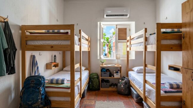 Habitación compartida con literas y mochilas para viajeros en un alojamiento de Puerto Rico